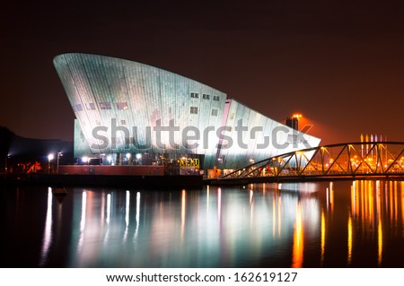 AMSTERDAM, NETHERLANDS - JULY 27: The Nemo Museum at night on July 27, 2013 in Amsterdam, Netherlands. Science Center NEMO is designed by Renzo Piano since 1997.