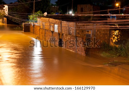 NOVA IGUACU, RIO DE JANEIRO, BRAZIL - DECEMBER 6: Poor living area flooded after heavy rain on 6th December, 2013. The water level of local river got few meters higher, many houses were flooded.