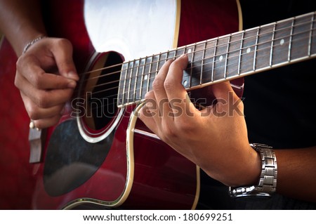 Hands of Young Man Playing Acoustic Guitar