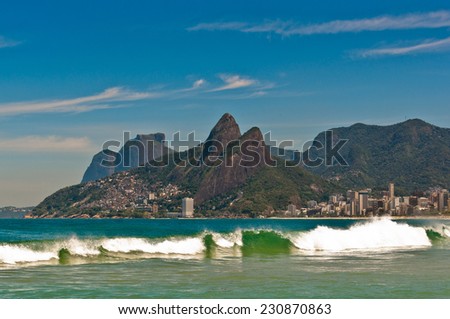 Wave in the Ocean at Ipanema Beach with Beautiful Rio de Janeiro Mountains on Horizon