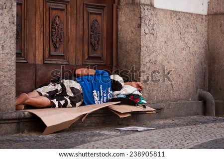 RIO DE JANEIRO, BRAZIL - DECEMBER 4, 2014: Homeless man sleeping at the church entrance. Even though economy of Brazil is growing rapidly, poverty remains a big issue there.