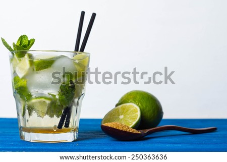 Fresh mojito drink on the blue wooden table