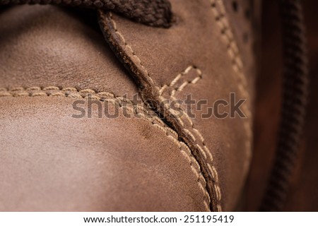 Close up view of brown boot with laces