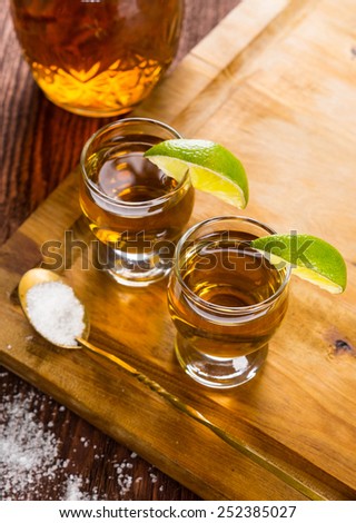 Tequila in shot glasses with lime and salt