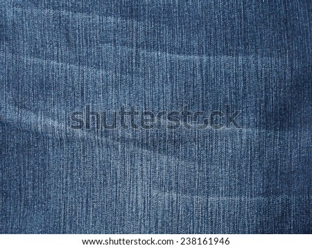 Worn jeans fabric plain surface background, blue denim textile texture