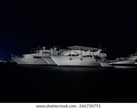 Diving safari yachts anchored at night marina