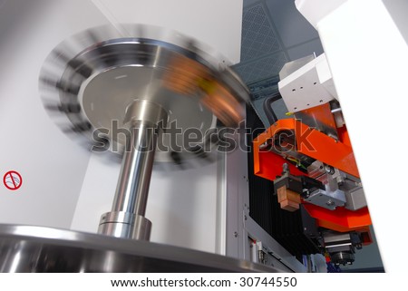 stock photo CNC machine with a mechanical arm and rotate tool changer