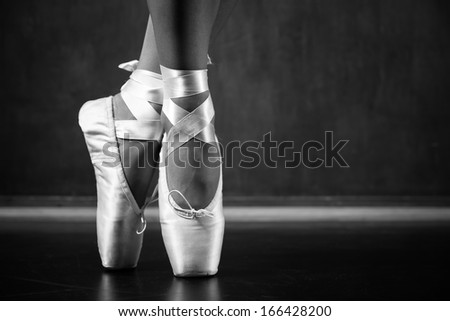 Young ballerina dancing, closeup on legs and shoes