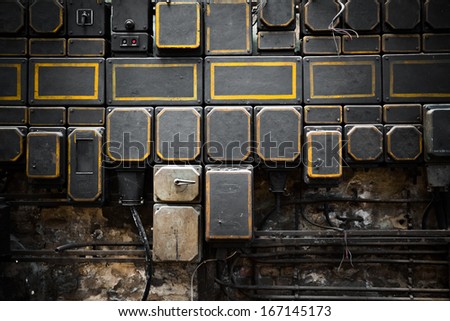 old brick building with electrical boxes, low light