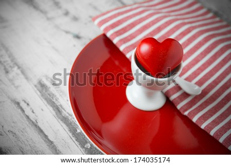 a red one heart in a red egg tray
