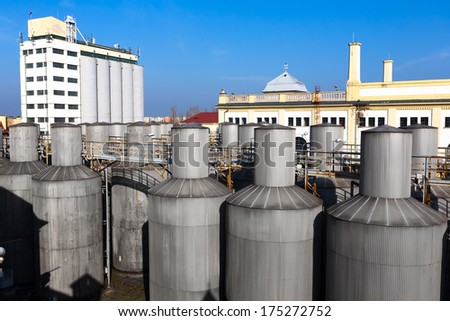 beer processing and storage silos against blue sky