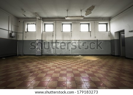 An old empty room, checkered tile floor