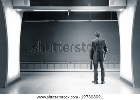 man waiting in a subway station