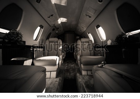 a luxury aircraft interior, leather seats, poor light