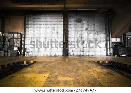 a dirty, oily door of the bus garage