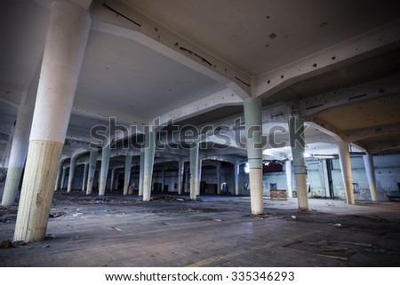 industrial interior of an abandoned factory building, poor light, color effect