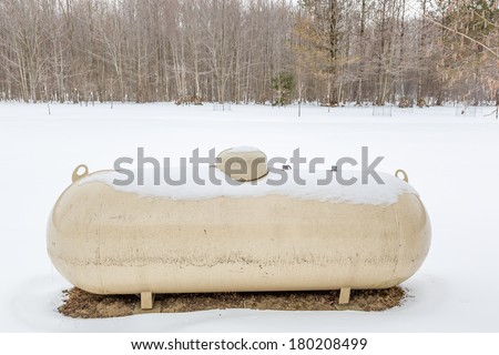 a bulk storage propane tank in a snow covered landscape