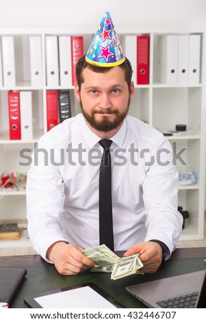 The man is sad, celebrating a birthday in the office of one