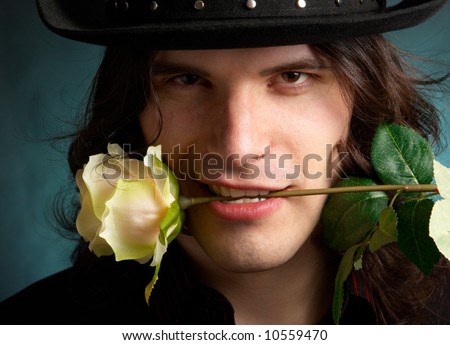 http://image.shutterstock.com/display_pic_with_logo/146392/146392,1206001406,2/stock-photo-the-man-in-a-hat-with-a-rose-in-a-teeth-10559470.jpg