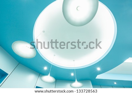 group of white lamp on blue ceiling in the modern interior