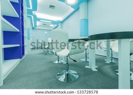 tables and white chairs in the empty modern library