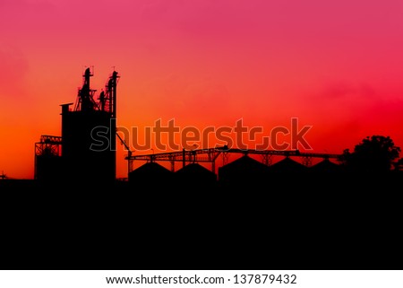 lime industry, silhouettes as against a background of red sunset sky