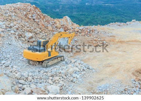 excavator loader machine during earthmoving works outdoors at dolomite mines site
