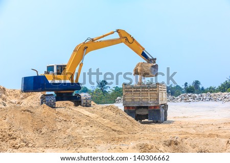 excavator loading sand on dumper truck at dolomite mines site