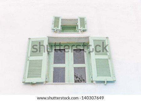 outer light green opened  and light green  inner closed window with white wall