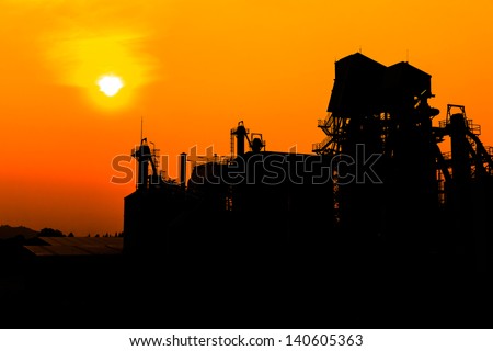 lime industry, silhouettes as against a background of orange sunset sky