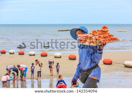 PATTAYA, THAILAND - MAY 25: Local merchant selling food to tourists at Pattaya beach on May 25, 13, it is a city in Thailand, a beach resort popular with tourists and expatriates