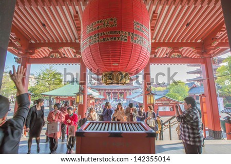 TOKYO -APRIL 11: Japanese pray worship at the Senso-ji Temple on April 11, 13 in Tokyo,Japan.The Senso-ji Buddhist Temple is the symbol of Asakusa and one of the most famed temples in all of Japan