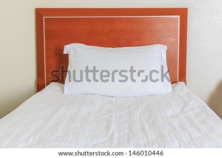 white pillow and single bed