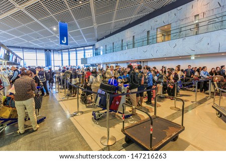 TOKYO - APRIL 13: Long  line of passengers checking in at Narita Airport on April 13, 2013 in Shinjuku district, Tokyo. It is the primary international airport serving the Greater Tokyo Area of Japan.