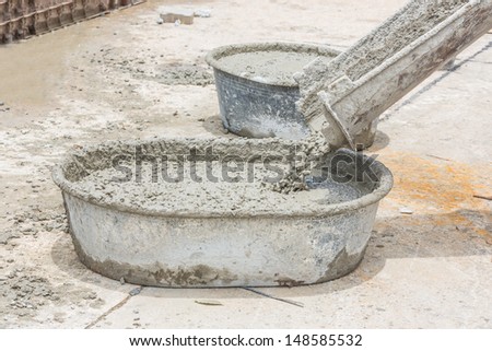 pouring of wet concrete  form concrete mixer into the tub
