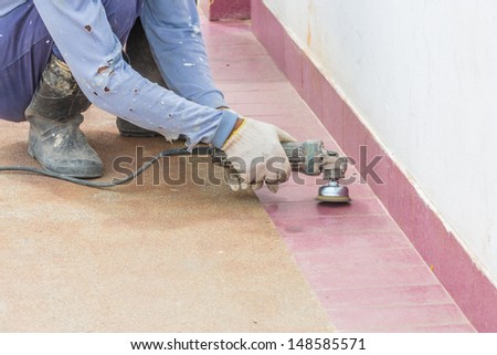 worker clean the floor using electric motor brushing