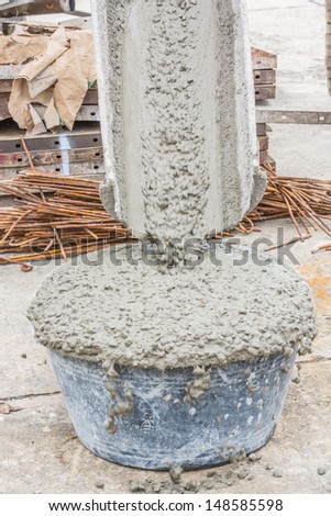 pouring of wet concrete  form concrete mixer into the tub