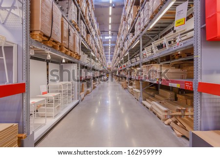 BANGKOK - OCTOBER 23: People pick up furniture component from the shelf at IKEA Bangkok Store on October 23, 2013 in Bangkok. Founded in Sweden in 1943, Ikea is the world\'s largest furniture retailer.