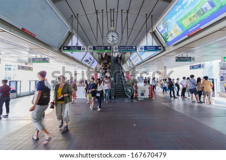 BANGKOK - DECEMBER 5: Passengers walk in BTS elevated rails in Siam Station on December 5, 2013 in Bangkok, Thailand. It\'s the first electric train system in Thailand.