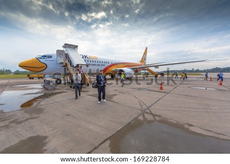 TRANG, THAILAND - DECEMBER 18: Passengers walk out from Nok Air Flight at Trang Airport on Dec 18, 13 in Trang, Thailand. Nok Air is the budget airline of Thai Airways International.