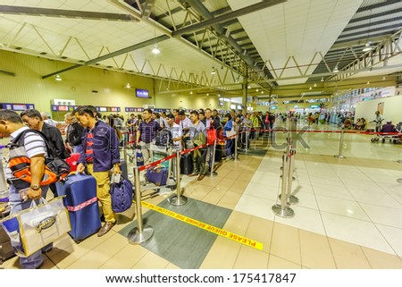 KUALA LUMPUR - DECEMBER 23: Passengers in Low cost carrier terminal (LCCT) on Dec 23, 2013 in Kuala Lumpur, Malaysia. It was opened to cater for the growing number of users of low cost airlines.