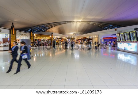 BANGKOK- FEB 10 : Passengers in the hallway at Suvanaphumi Airport, Bangkok on Feb 10, 2014. Suvarnabhumi airport is world\'s 4th largest single-building airport terminal.