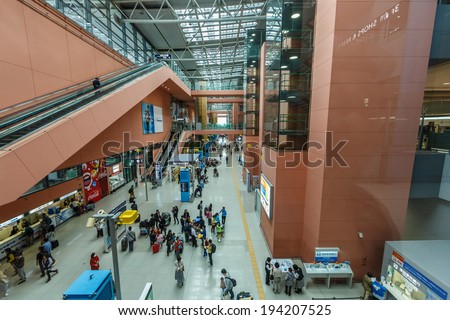 OSAKA- APRIL 5 : Passengers walk in the hallway at Kansai Airport, Osaka on Apr 5, 2014. It is an international airport located on an artificial island in the middle of Osaka Bay.