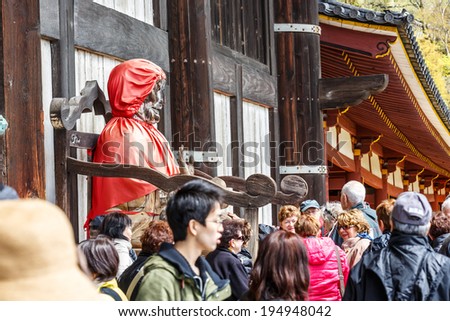 NARA, JAPAN - APRIL 6: Tourists visit Todai-ji temple on April 6, 14 in Nara. It is a Buddhist temple complex which houses the world\'s largest bronze statue of the Buddha Vairocana (Daibutsu).