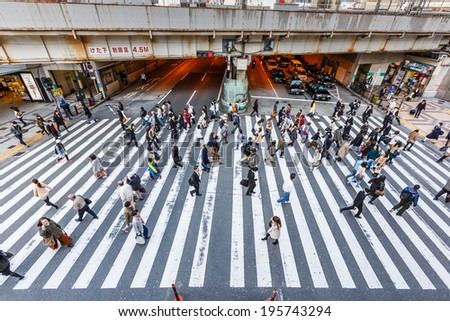 OSAKA - APR 7: People walk across the street  at Osaka station on Apr 7,14 in Osaka. It is a city in the Kansai region of Japan\'s main island of Honshu, a designated city under the Local Autonomy Law.