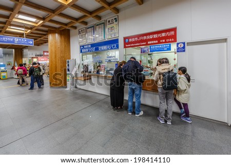 NARA, JAPAN - APR 6: Tourists ask info from JR Counter at Nara Station on Apr 6, 14 in Nara. It is a railway station located and main stop in city of Nara. Operated by West Japan Railway Company.