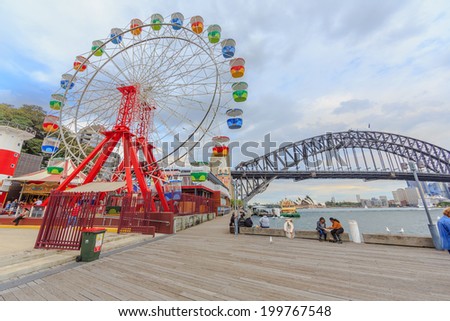 SYDNEY - MAY 10: Tourists visit Lunar Park on May 10, 14 in Sydney. It is an amusement park located at Milsons Point in Sydney, NSW, Australia.