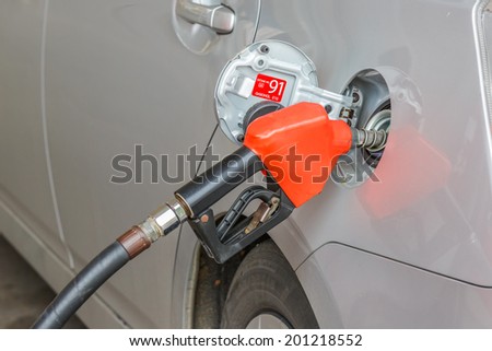 gasoline pump nozzles filling in the tank