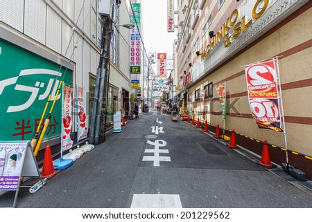 OSAKA -APRIL 7: Local street at Dotonbori on April 7, 14 in Osaka. It is one of the principal tourist destinations in Osaka, Japan. It is a single street, running alongside the Dotonbori canal.