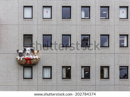 OSAKA - APR 7: Dogs sculpture on the buildein  on Apr 7, 14 in Osaka, Japan. Osaka city is in the Kansai region of Japan\'s main island of Honshu, a designated city under the Local Autonomy Law.